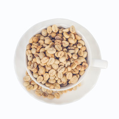 Raw coffee beans in coffee cup on open space.
