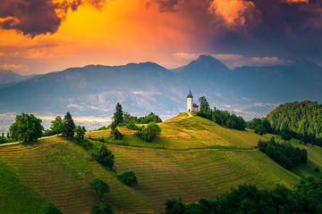 Alpine sunset landscape with Saint Primoz church, near Jamnik, Slovenia - obrazy, fototapety, plakaty