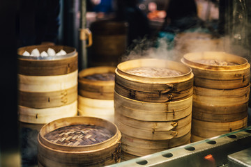 Piles of stacking bamboo steamers are steaming for dim sum. Street food of Jiantan in Taipei, Taiwan.