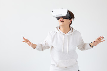 Modern technologies, future and people concept - Woman 40-50 years old wearing virtual reality glasses on white background