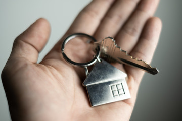 Obraz premium closeup key on human hand, personal loan concept. soft focus.