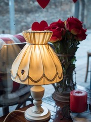 lamp on the table with roses