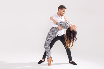Social dance, kizomba, tango, salsa, people concept - beautiful couple dancing bachata on white...