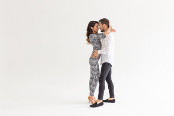 Salsa, kizomba and bachata dancers on white background with copy space. Social dance concept