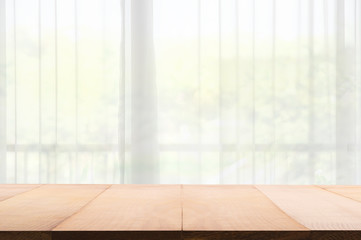 Empty of wood table with Blur of curtain window from green garden view in morning background.