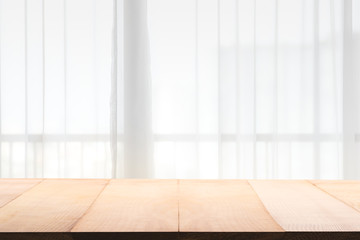 Empty of wood table with Blur of curtain window.