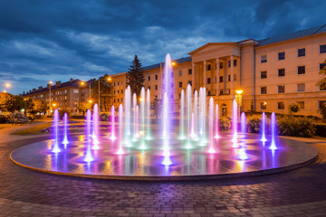 Fountain in Banska Bystrica at night. Multicolor water fountain in historical city centre in Banska Bystric. New attraction in central Slovakia.