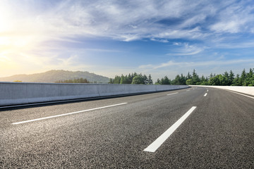 Fototapeta premium Country asphalt road and green woods nature landscape in summer
