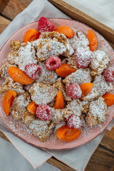 Kaiserschmarrn - traditional austrian pancake dessert with fresh fruit