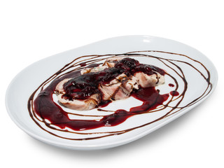 Baked meat with plum sauce on a plate