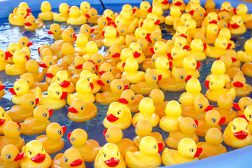 Fototapeta na wymiar A background of hundreds of rubber duckies in a pool