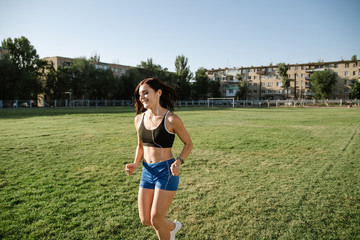Young beautiful woman running and listening to music with headphones.
