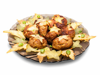 Fried meat with pickled cucumbers garnished with fried potato stars and peas