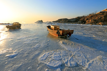 wooden boat in sea ice