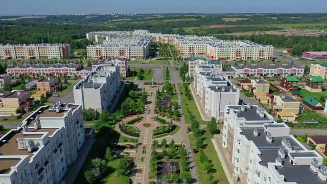 aerial view over a housing estate and residential buildings with roads, cars, green parks in satellite city Kemerovo - Lesnaya Polyana, Russia