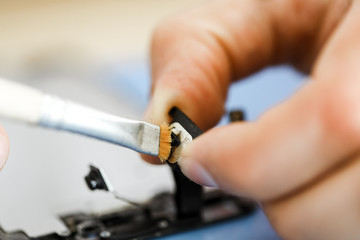 Close-up photos showing process of mobile phone repair