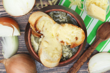 A ceramic pot with French onion soup