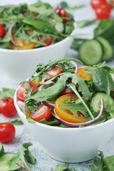Two bowls full of vegetable salad