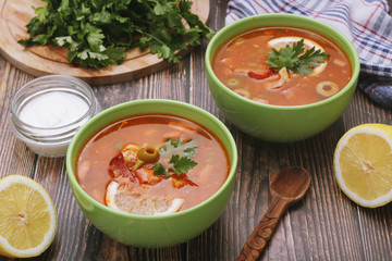 Two bowls with traditional Russian soup solyanka	