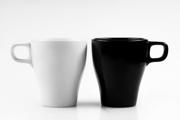 White mug and black mug on a white background