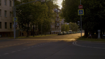 Crosswalk at sunset. Cars on the street