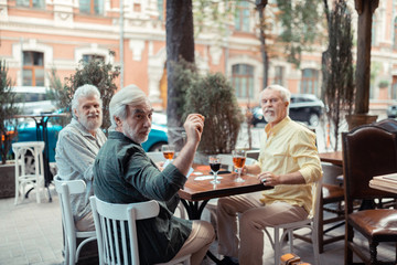Bearded men calling waiter while asking for receipt