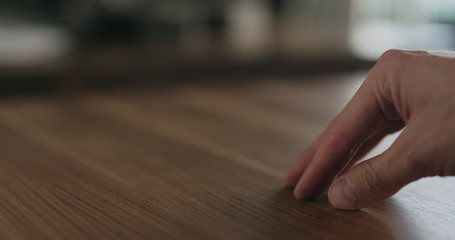 woodworker checking oil finish on black walnut