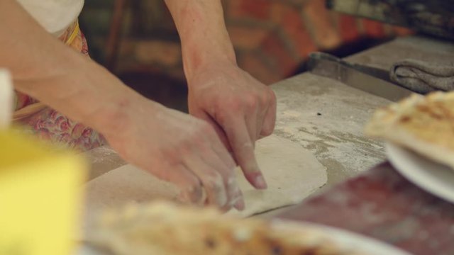Man makes pita breads  in local Bulgarian restaurant