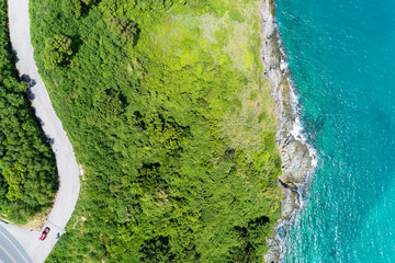 Asphalt rural road curve on high mountain with tropical sea image by Drone aerial view Top down