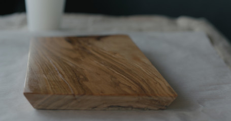 woodworker applying oil finish to olive wood board
