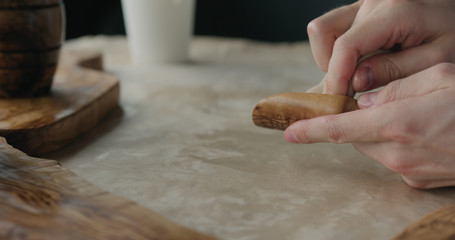 woodworker applying oil finish to olive wood scoop