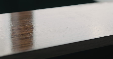 Fototapeta premium applying oil finish with brush to black walnut board