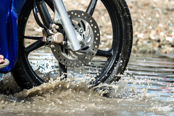 motion motorcycle  rain big dirty puddle of water spray from the wheels