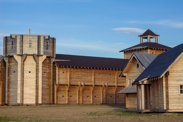 Fototapeta premium courtyard of an ancient reconstructed wooden fortress with high walls and a bell tower