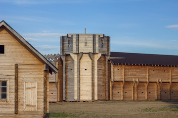 Fototapeta na wymiar courtyard of an ancient wooden fortress with high walls and a tower