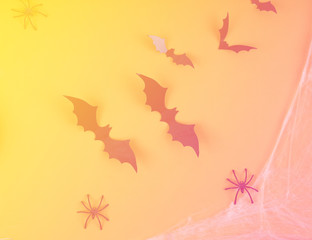 Halloween bats on orange and yellow background in neon toning with gradient