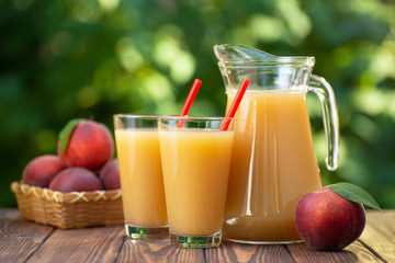 peach juice in glasses and jug