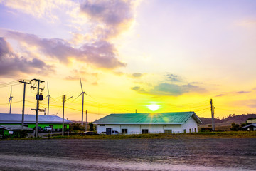 Fototapeta premium Landscape mountain view with windmills on the hill with sunset sky, Wind turbine generator to build electricity power in rural area, Electricity power concept