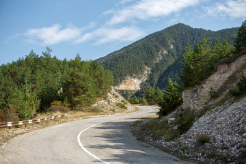 Naklejka premium Photo of picturesque mountain area, road, blue sky with clouds
