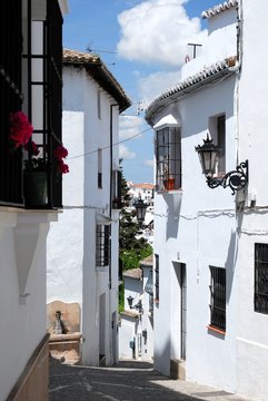 View along a steep street in the old town, Ronda, Andalusia, Spain.