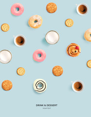 Creative layout made of donuts, cookies, milk and coffee on blue background. Flat lay. Food...
