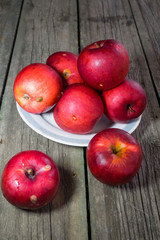 Red apples on a wooden background