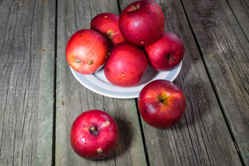Red apples on a wooden background