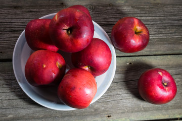 Red apples on a wooden background