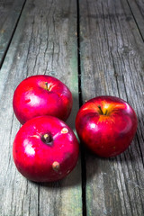 Red apples on a wooden background