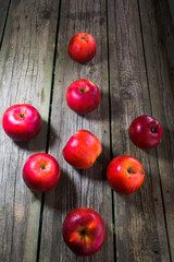 Red apples on gray wooden background.