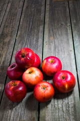 Red apples on gray wooden background.