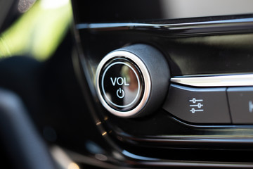 Naklejka premium Volume button on a modern car. Black knob with chrome trim.