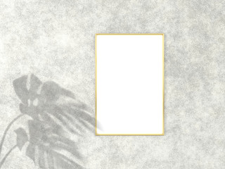 2x3 vertical Gold frame for photo or picture mockup on concrete background with shadow of monstera leaves. 3D rendering.