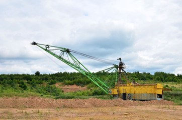 Fototapeta premium Biggest excavator dragline with a large bucket for the quarry overburden stripping. Belarus, Vitebsk, largest dolomite deposit in a open pit 